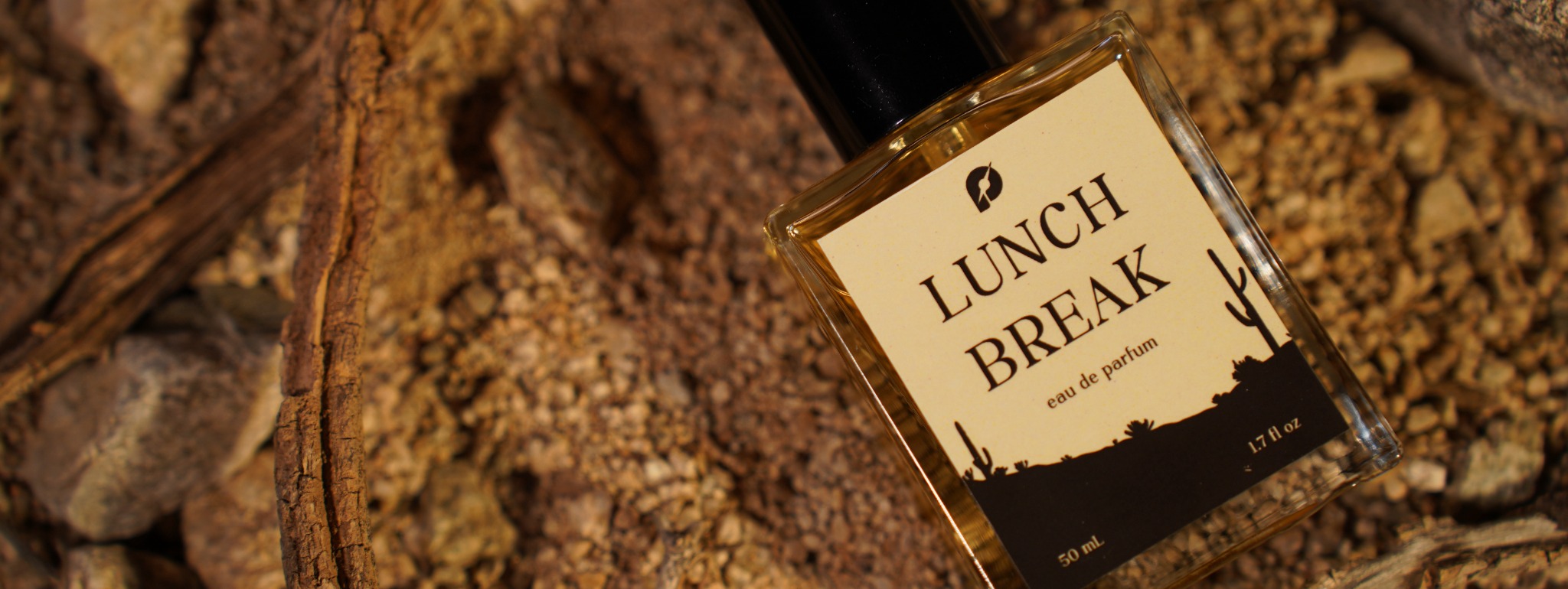 Lunch Break fragrance bottle photographed in a desert setting
